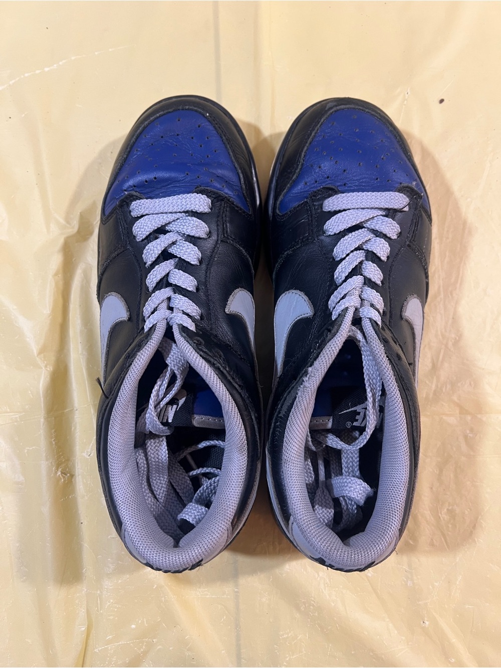 Nike White Athletic Shoe with Blue Interior and Black Heel Accent
